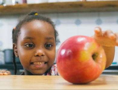 girl-making-a-healthier-choice-and-reaching-for-an-apple